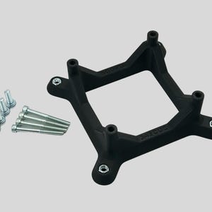 May include: A black square bracket with four mounting holes and several silver screws. The bracket has a unique shape with curved edges and is designed for a specific purpose. The screws are of varying lengths and are likely used for securing the bracket.