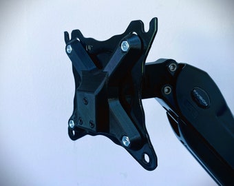 May include: Black monitor arm with a metal mounting plate and a swivel arm. The arm is labeled "InVision".