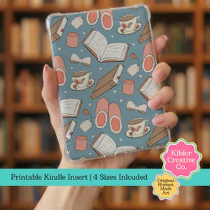 May include: A clear Kindle case with a blue background featuring a pattern of books, teacups, slippers, candles, and bows. The text "Printable Kindle Insert | 4 Sizes Included" is at the bottom. The case is held in a person's hand.