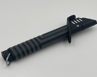 May include: A black lightsaber with a textured grip and a silver button. The lightsaber has a black and silver handle with a silver button on the side.