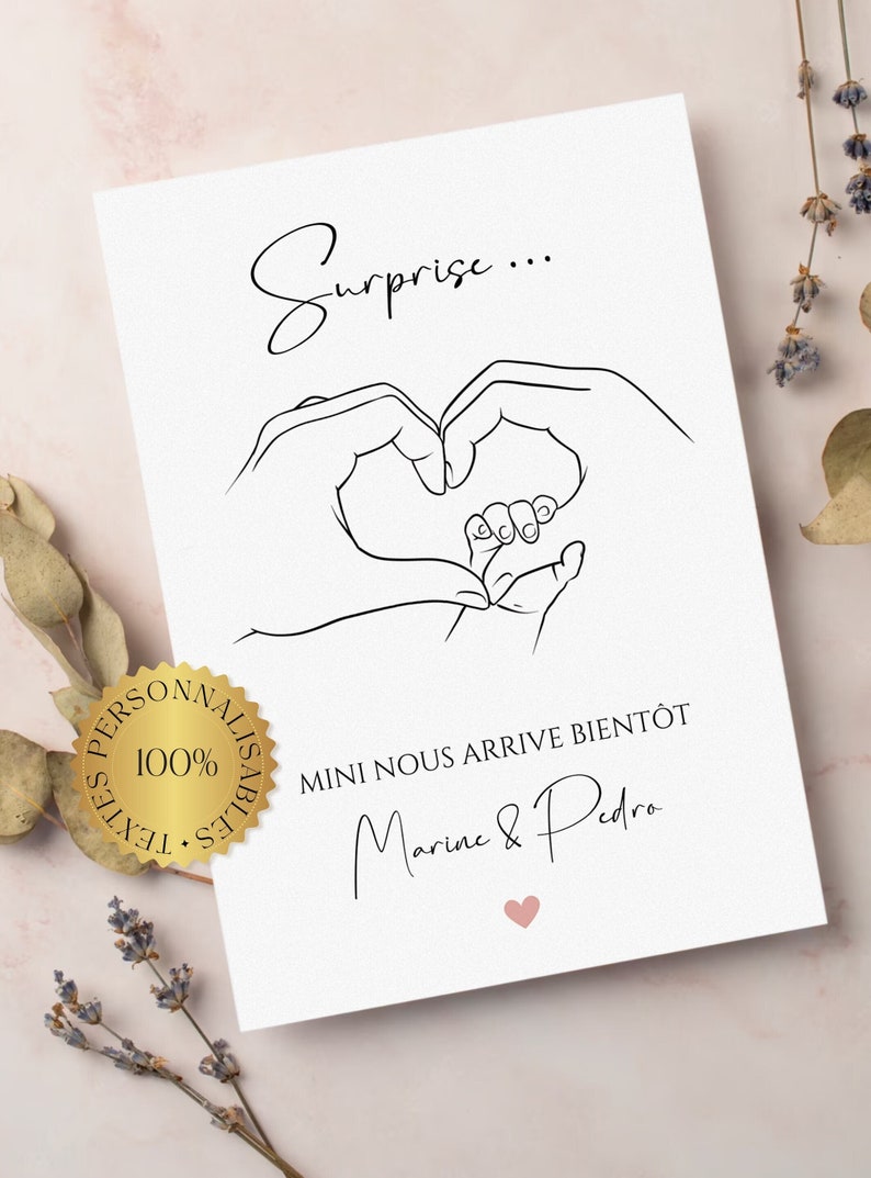 May include: White card with a black line drawing of hands forming a heart around a baby's foot. Text includes "Surprise..." and "MINI NOUS ARRIVE BIENT&Ocirc;T Marine & Pedro" with a pink heart.