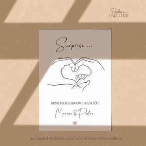 May include: A beige card with black line art of hands forming a heart around a baby's foot. The text "Surprise..." is above the heart. Below the heart is the text "MINI NOUS ARRIVE BIENT&Ocirc;T" and the names "Marine & Pedro". A pink heart is at the bottom.