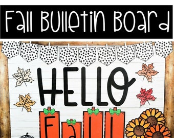 Könnte beinhalten: Ein Herbst-Bulletin Board mit einem schwarz-weißen Polka-Dot-Banner, den Worten "Hello Fall" in Schwarz und verschiedenen herbstlichen Dekorationen, darunter Kürbisse, Blätter und Sonnenblumen.