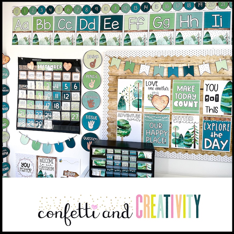 May include: A classroom bulletin board decorated with a woodland theme. The board features a calendar, alphabet chart, and various posters with inspirational messages like "Love one another" and "Explore the day".