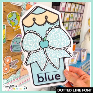 May include: A die-cut paper cutout shaped like a pencil in light blue and pale yellow. It features a large bow with a speckled pattern and a small teal apple icon in the center. The word blue is printed at the bottom in a dotted line font.
