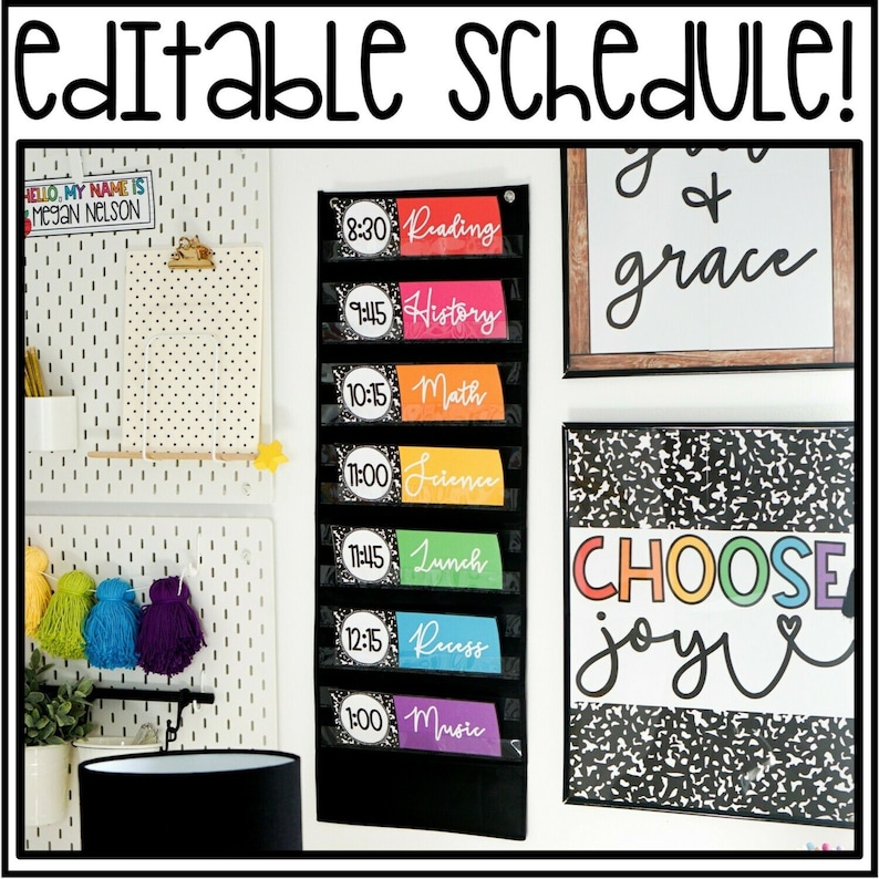 May include: A black pocket chart with colorful labels for a classroom schedule. The labels include times and subjects like Reading, History, Math, Science, Lunch, Recess, and Music. The chart is hanging on a white pegboard wall with other classroom decor.