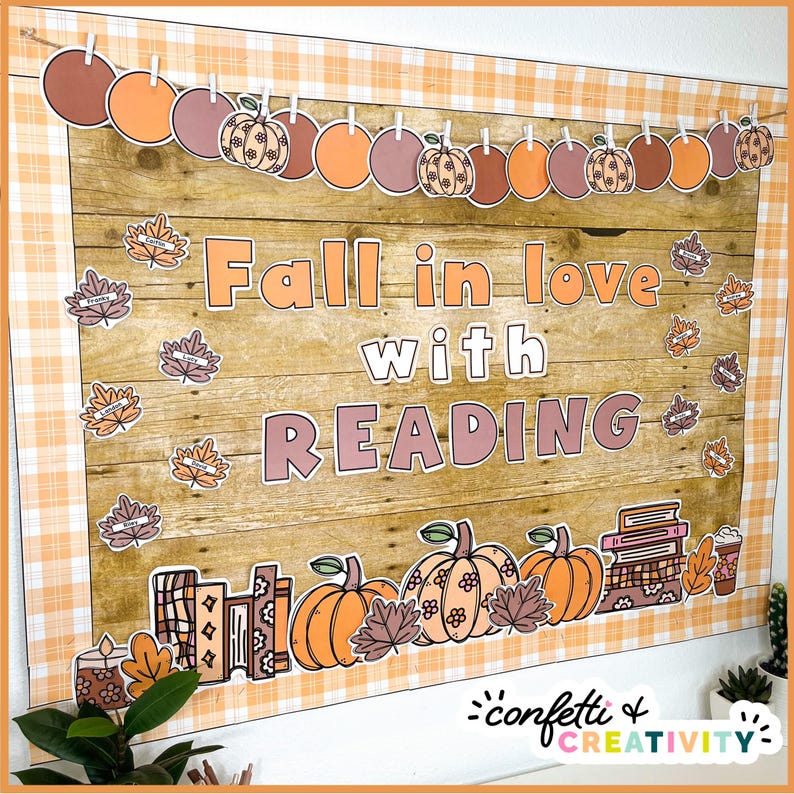 May include: A bulletin board decorated with a fall theme. The board has a wooden background and is decorated with orange, brown, and white pumpkins, leaves, and books. The text "Fall in love with READING" is displayed on the board.