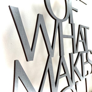 May include: Close-up of a wooden wall art piece with the words "Some of what makes life"