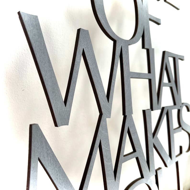 May include: Close-up of a wooden wall art piece with the words "Some of what makes life"
