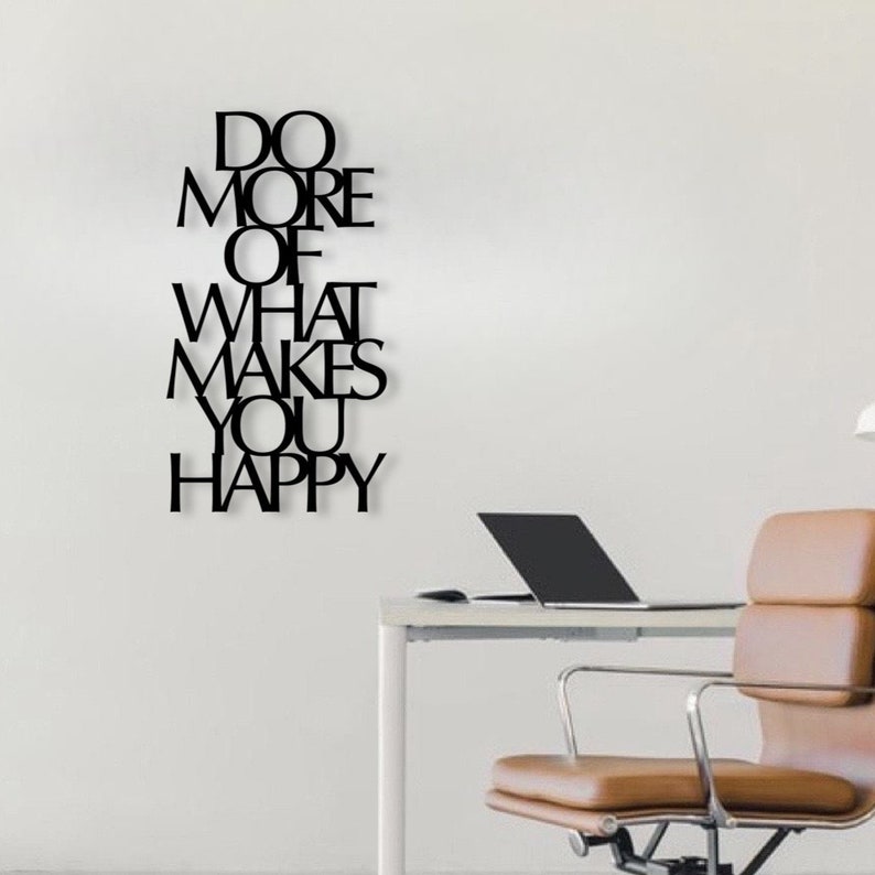 May include: Black metal wall art with the words "Do More Of What Makes You Happy" in a modern font.
