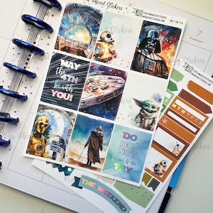 May include: A set of Star Wars themed planner stickers featuring characters like Darth Vader, Yoda, R2-D2, and BB-8. The stickers are colorful and have a watercolor-like design. The stickers include phrases like "May the 4th be with you!" and "Do or do not, there is no try."