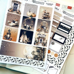 May include: A set of Halloween themed planner stickers featuring images of a spooky house, a witch's cauldron, a graveyard, bats, and a skull. The stickers are printed on white paper and have a matte finish. The stickers are 1.5 inches in size.
