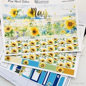 May include: A set of sunflower themed planner stickers with a watercolor background. The stickers include a monthly header with the word "May" in gold lettering, daily boxes, and a variety of decorative elements. The stickers are designed for use in a planner or journal.