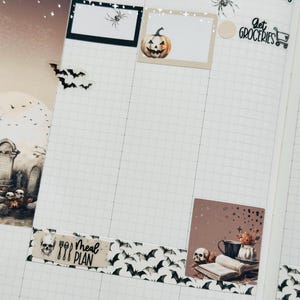 May include: A weekly planner with a Halloween theme. The planner has a grid layout with days of the week labeled: Monday, Tuesday, Wednesday. The planner has a variety of stickers, including a pumpkin, a skull, a spider, bats, and a "Get Groceries" sticker with a shopping cart icon. The planner also has a "Meal Plan" sticker with a skull and cutlery.