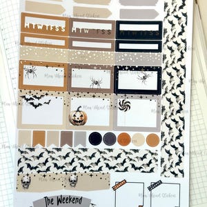 May include: A set of Halloween themed planner stickers featuring bats, spiders, pumpkins, and candy corn. The stickers are in various colors, including black, orange, brown, and white. The stickers are designed to be used in a planner or journal.