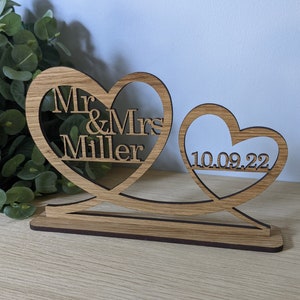 May include: Wooden heart-shaped wedding sign with the text "Mr & Mrs Miller" and the date "10.09.22".