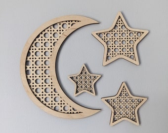 May include: Three wooden wall decor pieces in the shape of a crescent moon and two stars. The moon and stars have a woven pattern.