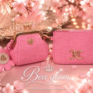 May include: Pink coin purse and wallet set with gold accents. The coin purse has a kiss-lock closure and a heart-shaped emblem. The wallet features a zipper closure and embossed patterns. The text "Bea glam" is visible.