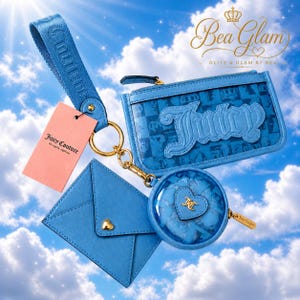 May include: A collection of light blue Juicy Couture accessories against a sky background. Includes a wristlet, a coin purse, a card holder, and a zippered wallet, all featuring the Juicy Couture logo. A pink tag is also visible.