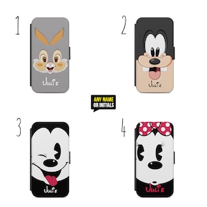 May include: Four different phone cases featuring Disney character designs. The cases are black, grey, and white with various characters including Mickey Mouse, Minnie Mouse, and a rabbit. The cases have the name "Julie" printed on them.
