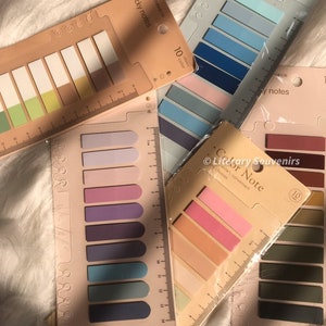 May include: A selection of colourful sticky note pads with rulers. The pads display a variety of colour schemes, including blues, greens, pinks, and purples. Each pad contains 10 colours. The text "Sticky notes" and "Color Note" are visible.