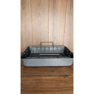 May include: Black metal roasting pan with a removable wire rack. The pan is designed for roasting poultry or other large cuts of meat.