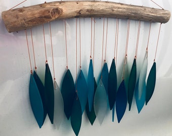 Bamboo Habitat hand made wind chimes made from recycled glass with driftwood style hanger. Blueish tones.