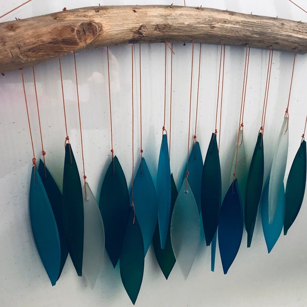 Bamboo Habitat hand made wind chimes made from recycled glass with driftwood style hanger. Blueish tones.