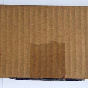 May include: A cardboard box with a label that reads "DESC: Simplylis. Rainbow". The label also shows a picture of a rainbow-colored wind chime.