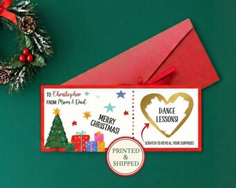 May include: A rectangular Christmas gift card featuring a green tree, colorful presents, and stars. The text reads: TO: Christopher, FROM: Mom & Dad, MERRY CHRISTMAS!, DANCE LESSONS!, and SCRATCH TO REVEAL YOUR SURPRISE!. A gold heart covers the surprise text.