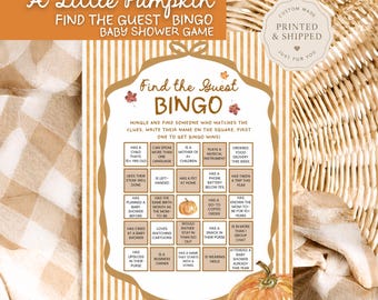 May include: A Find the Guest Bingo baby shower game card featuring a white background with gold vertical stripes, a central decorative frame, and autumn leaf accents. The card includes a 5x5 grid with text prompts and a pumpkin illustration.