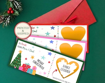 May include: Three rectangular Christmas scratch-off cards with white backgrounds, colorful stars, and gift graphics. Each card features a gold heart to scratch off, revealing text like DANCE LESSONS, with TO and FROM fields and MERRY CHRISTMAS printed on the front.
