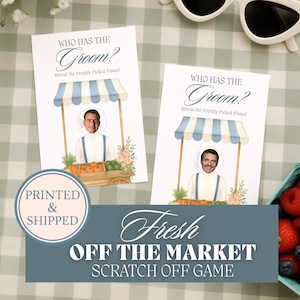 May include: Two white cards with the text "Who Has The Groom?" and "Fresh Off The Market Scratch Off Game". Each card features a cartoon of a market stall with a photo cutout. The cards are on a checkered surface.