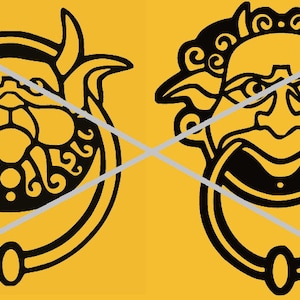 May include: Two black door knockers with detailed face designs on a yellow background. One knocker features a horned face, the other a face with a large mouth and curly hair. The knockers have a ring for knocking.