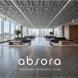 May include: An open, modern office space with large windows overlooking a cityscape. The ceiling features a geometric pattern of gray acoustic tiles. The floor is polished concrete, and the room is furnished with gray sofas, wooden tables, and plants. The text "absora DESIGNER ACOUSTIC TILES" is displayed.