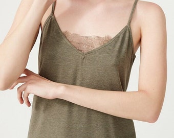 May include: An olive green camisole top featuring thin spaghetti straps and a V-neckline with a delicate, matching lace trim insert. The garment is crafted from a soft, heathered fabric and is paired with matching olive green shorts.