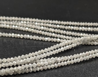 May include: A strand of white diamond beads. The beads are faceted and have a rough, natural look.