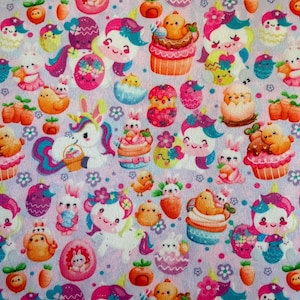 May include: A light purple fabric with a repeating pattern of Easter-themed illustrations. The design includes unicorns, bunnies, chicks, cupcakes, carrots, and decorated eggs in bright colors like pink, orange, and blue. The overall theme is whimsical and festive.