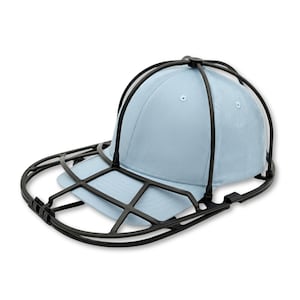 May include: A light blue baseball cap secured inside a black plastic cage-style hat washer frame. The frame consists of a rounded dome structure that covers the crown and a flat, oval-shaped base that supports the brim of the cap for cleaning.