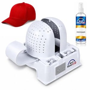 May include: A red baseball cap, a white plastic hat shaper device with a perforated dome and control panel, and a clear spray bottle labeled HAT SHAPER+ STIFFENER 8 FL OZ (236 mL). The device features a base with a power button and settings.