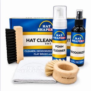 May include: A 5-in-1 hat cleaning kit including a blue and white box, a wooden brush with black bristles, a white microfiber cloth, a round wooden brush, a bottle of foam cleaner, and a 4.0 fl oz bottle of deodorizer, all labeled Hat Shaper.