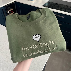Stardew Exhausted Embroidered Unisex Green Sweatshirt | Cosy gaming, Gamer, Gift Idea, Junimo, Farming, Sweater, Animal, Mug, T-Shirt