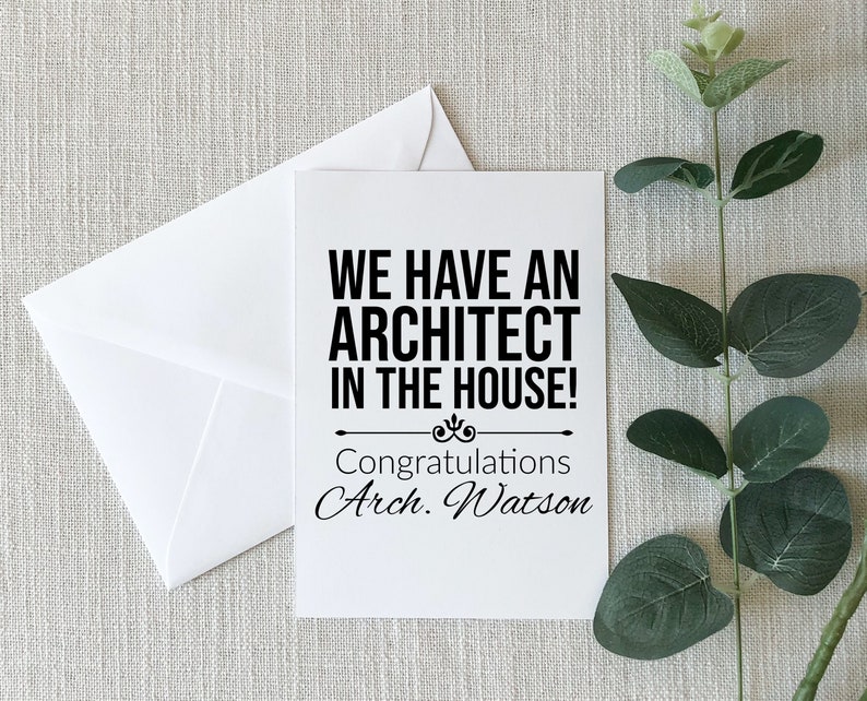 May include: A white card with black text that reads "We have an architect in the house!" and "Congratulations Arch. Watson".