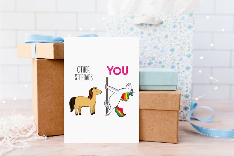 May include: A white card with a humorous illustration comparing other stepdads to a horse and the current stepdad to a unicorn doing a pole dance. The text on the card reads "Other Stepdads" and "You".