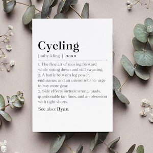May include: A black and white printable definition of the word "Cycling" with the phonetic spelling and the noun definition. The definition includes three points about the activity of cycling, including the side effects. The text ends with "See also: Ryan."
