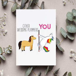May include: A white card with a pink and black text that reads "Other Wedding Planners" and "You". The card features a cartoon illustration of a brown horse and a unicorn with a rainbow mane and tail, dancing on a pole.