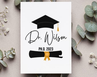 May include: A white card with a black graduation cap, a black scroll, and the text "Dr. Wilson PH.D. 2023".