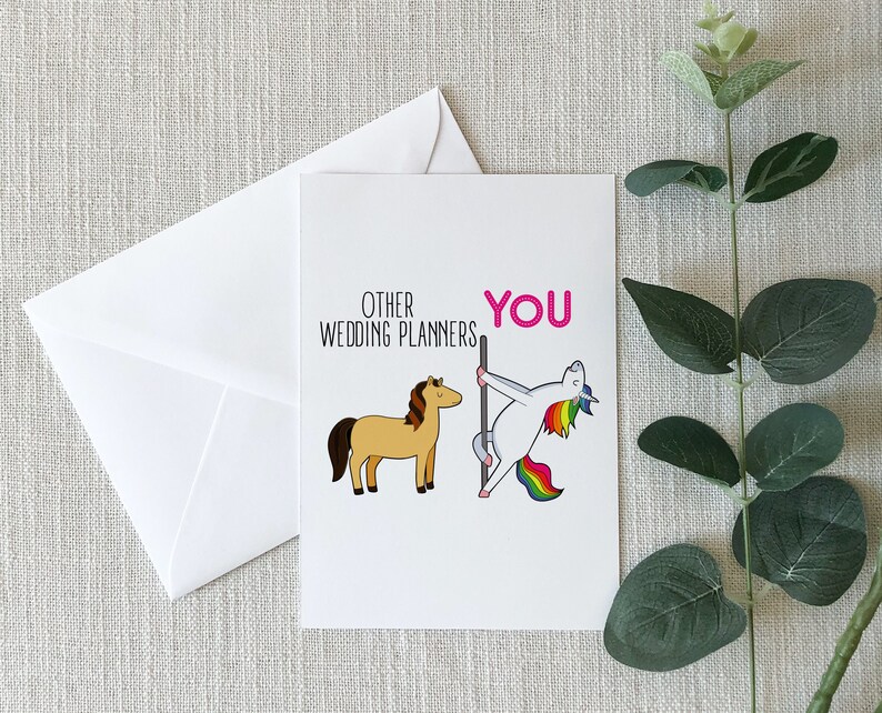 May include: A greeting card with a humorous illustration comparing wedding planners to a horse and a unicorn. The text reads "Other Wedding Planners" next to a brown horse and "You" next to a unicorn doing a pole dance.