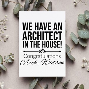 May include: A white card with black text that reads "We have an architect in the house!" with a decorative flourish and the text "Congratulations Arch. Watson" below.