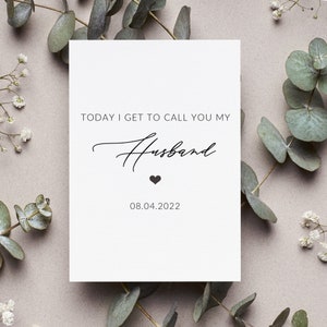 May include: White card with black text that reads "Today I get to call you my Husband" with a small heart symbol and the date "08.04.2022".
